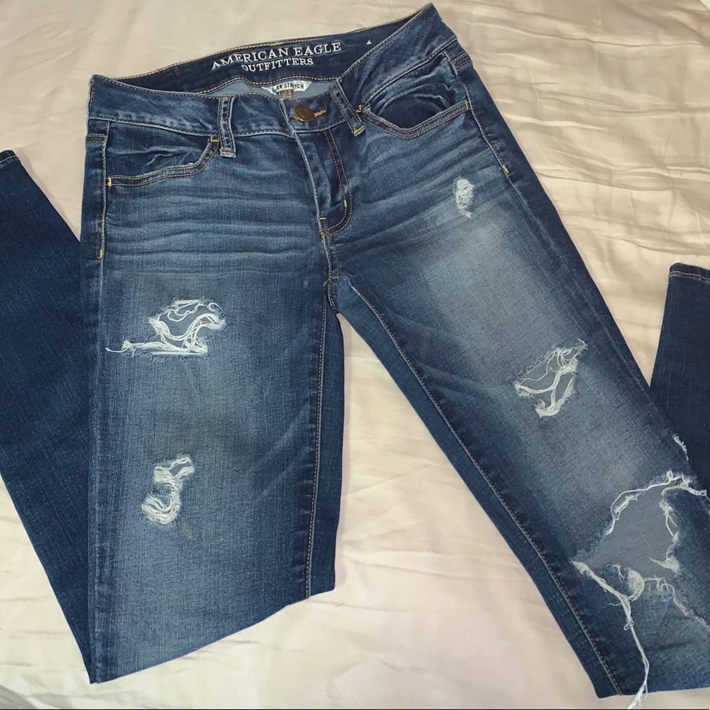 Medium wash ripped “super stretch” skinny jeans